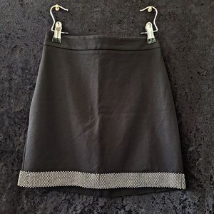 Black stretch knit mini skirt with rhinestone trim